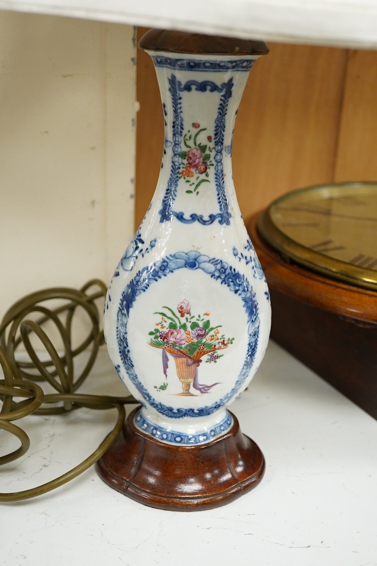 Two Chinese famille rose vases from a garniture, Qianlong period (1736-95), mounted as table lamps with shades, raised on shaped wood bases, overall 62cm high